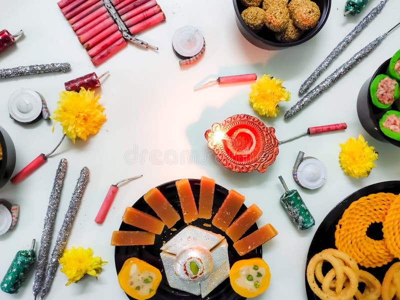 Closeup of Sweets, snacks and Fire Crackers isolated in a White background with selective focus and copy space. Diwali royalty free stock photography
