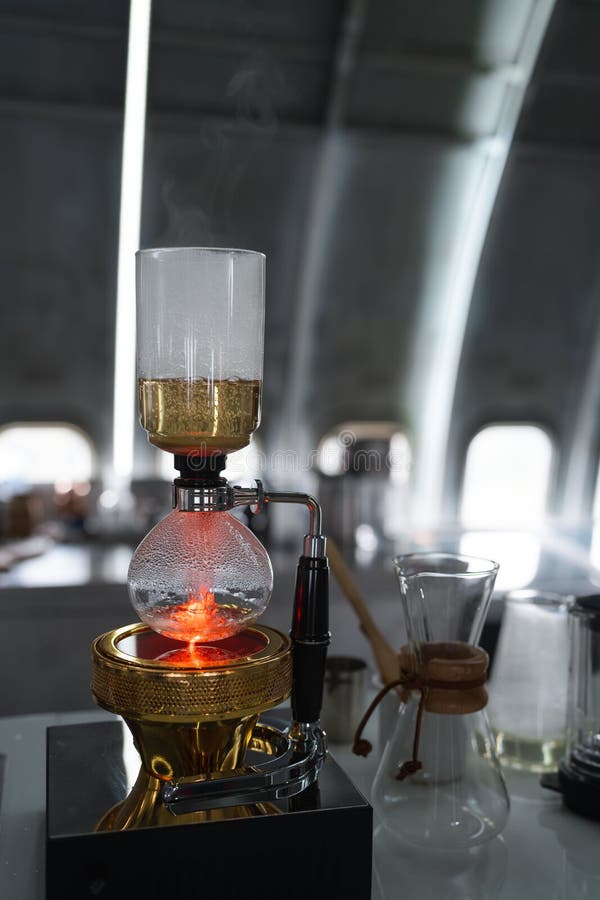 Syphon Coffee Maker Brewing Hot Espresso on Table Bar in Coffee Shop