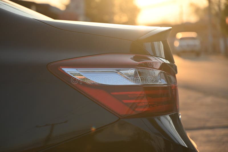 Closeup Tail Light of Black Modern Car in the Morning Stock Photo