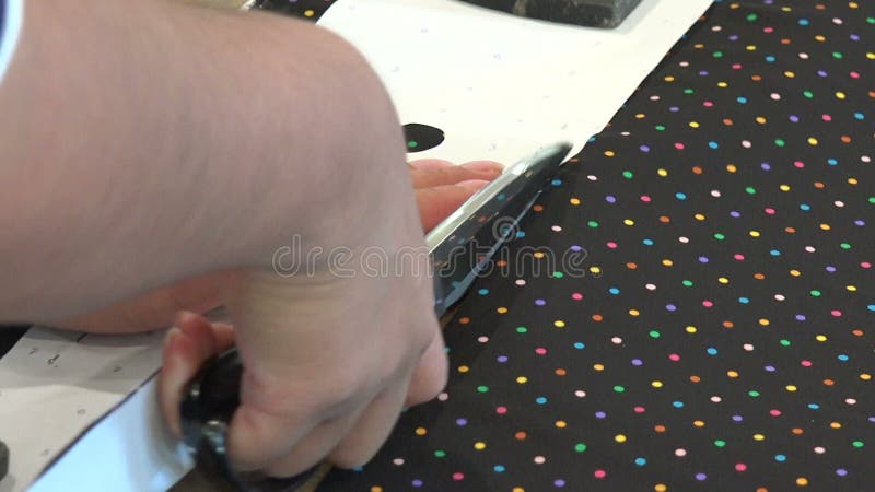 Closeup of a tailor cutting fabric with scissors stock video
