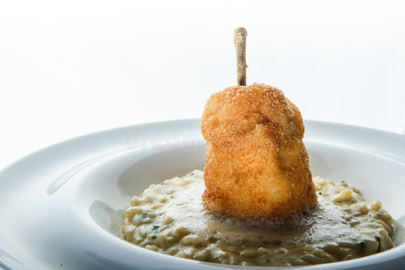 closeup tasty baked breaded whole pear on boiled barley porridge royalty free stock photo closeup tasty baked breaded whole pear on boiled barley porridge royalty free stock photo
