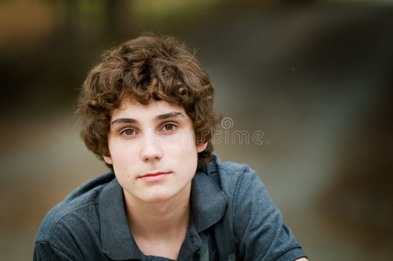 Closeup of a Caucasian teen boy outdoors looking at camera. Closeup of a Caucasian teen boy outdoors looking at camera