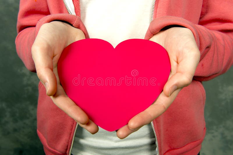 Closeup of teen girl iholding red heart