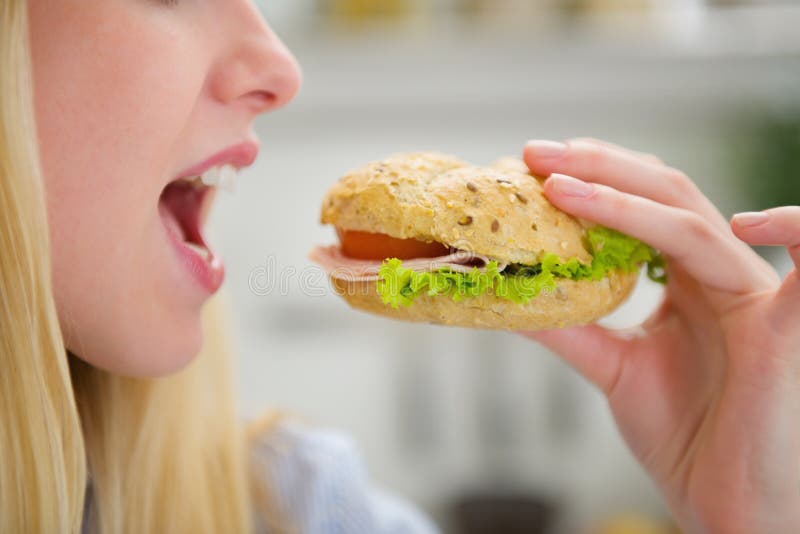 Closeup on teenager girl eating burger stock photo Closeup on teenager girl eating burger stock photo