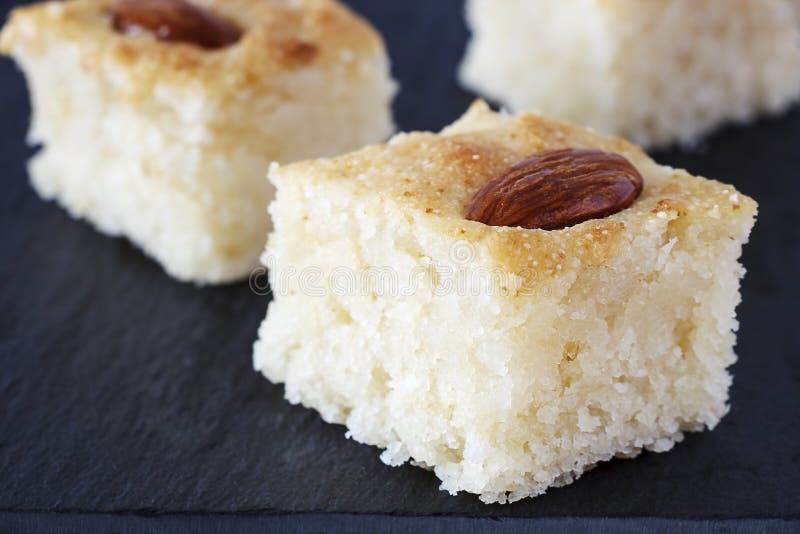 Closeup Three Pieces Basbousa Traditional Arabic Semolina Cake with Almond Nuts Orange Blossom Water. Copy space. stock image Closeup Three Pieces Basbousa Traditional Arabic Semolina Cake with Almond Nuts Orange Blossom Water. Copy space. stock image