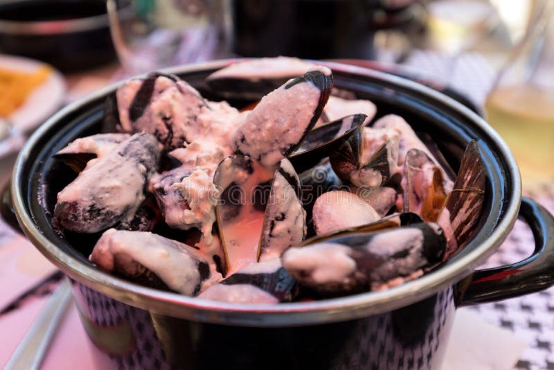 Closeup of traditional dish of French cuisine, appetizing mussels with sauce in Pyla-sur-Mer. stock images Closeup of traditional dish of French cuisine, appetizing mussels with sauce in Pyla-sur-Mer. stock images