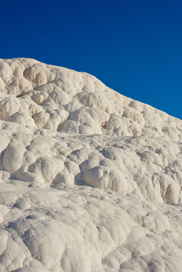 Closeup of travertine pools and terrace in Pamukkale, Turkey in a famous tourism holiday or vacation destination. Cotton castle area with carbonate mineral after flowing thermal spring water.