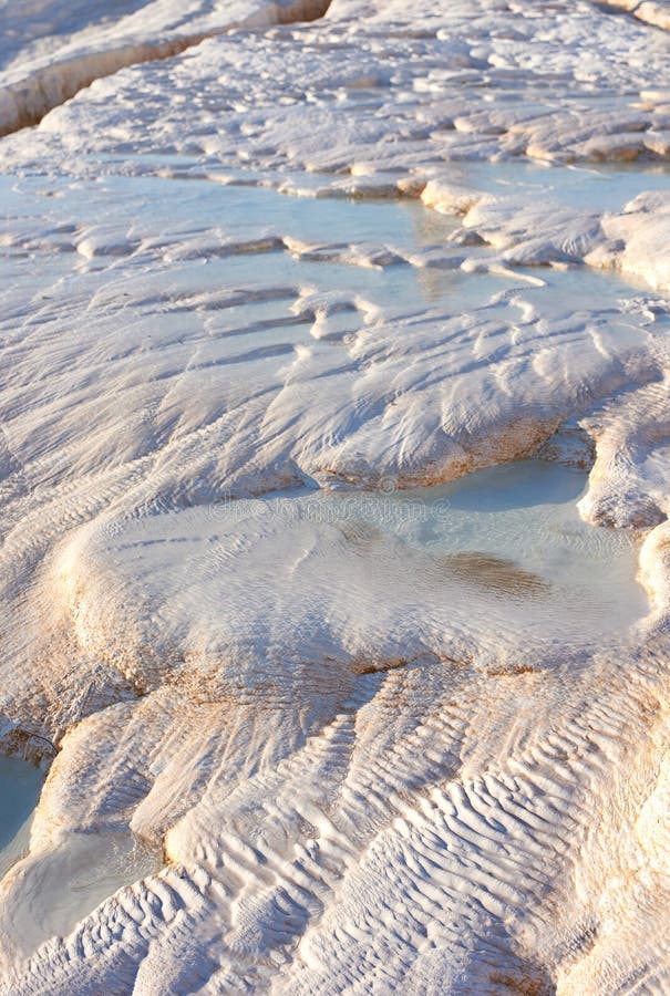 Closeup of travertine pools and terraces in Pamukkale, Turkey. Travelling abroad, overseas for holiday, vacation, tourism. Cotton castle area with carbonate mineral after flowing thermal spring water.