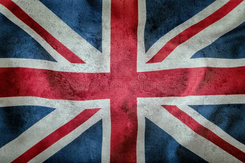 Closeup of Union Jack flag. UK Flag. British Union Jack flag blowing in the wind. Concrete background.