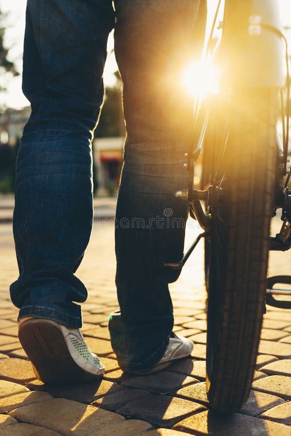 Closeup Unrecognizable Male Feet And City Bicycle Wheels, Rear View And Low Angle Holiday Weekend Activity stock image Closeup Unrecognizable Male Feet And City Bicycle Wheels, Rear View And Low Angle Holiday Weekend Activity stock image