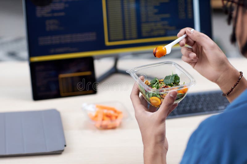 Closeup Of Unrecognizable Man Eating Takeout Lunch At Workplace Stock Closeup Of Unrecognizable Man Eating Takeout Lunch At Workplace Stock