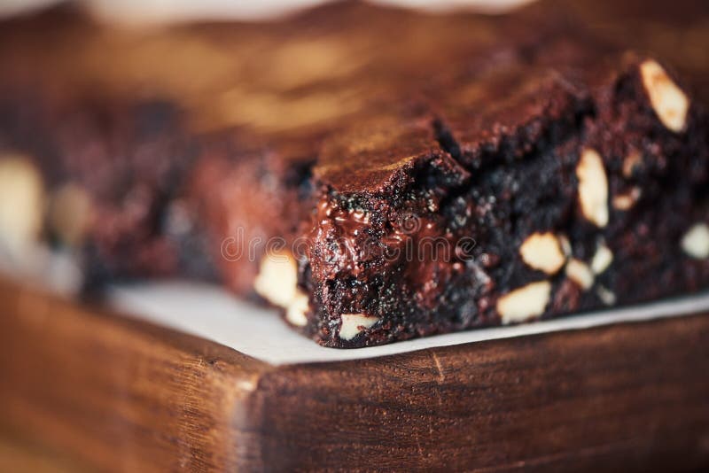 Closeup up of gooey chocolate brownies sitting on a table stock image Closeup up of gooey chocolate brownies sitting on a table stock image