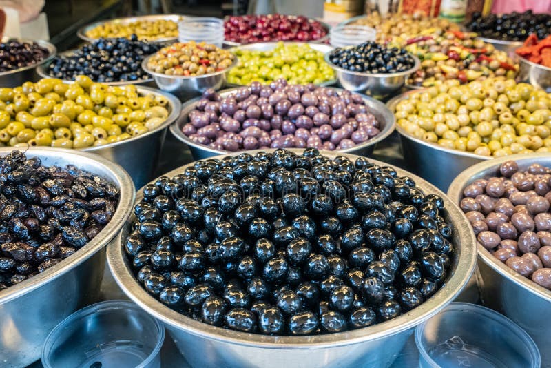 Closeup of the Varieties of Olives in Metallic Bowls on the Table Under