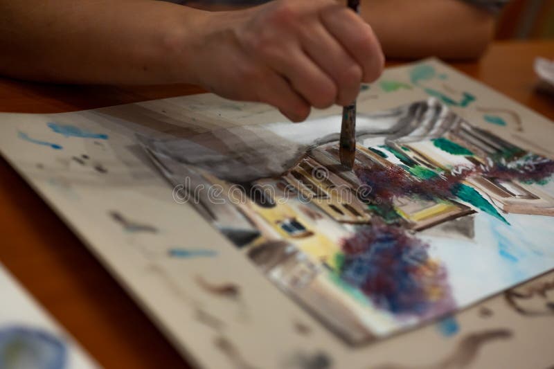 Closeup of watercolor painting process. Paintbrush taking color from inf  palette. Colorful medieval city street on paper board Stock Photo - Alamy