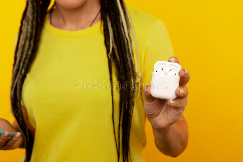 Closeup view of airpods box in woman`s hand isolated.