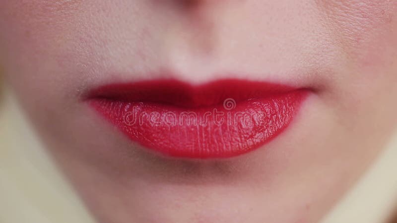 Closeup view of female mouth chewing gum. Woman with red lips and bad manners