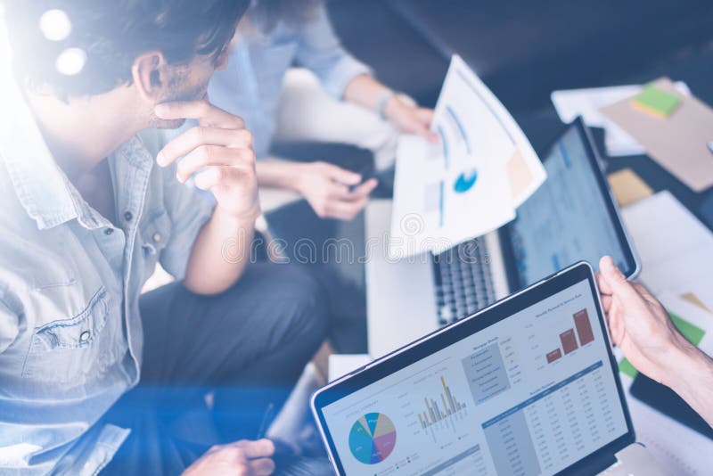 Closeup view of Group of young coworkers working together in modern office studio.Business people discussing new startup stock photography Closeup view of Group of young coworkers working together in modern office studio.Business people discussing new startup stock photography
