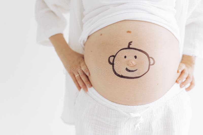 Closeup View Pregnant Belly of Woman with Drawn Smiling Baby Face on it ...