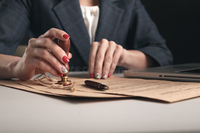 Closeup View of Woman Attorney Writing on Documents by Pen. Stock Photo