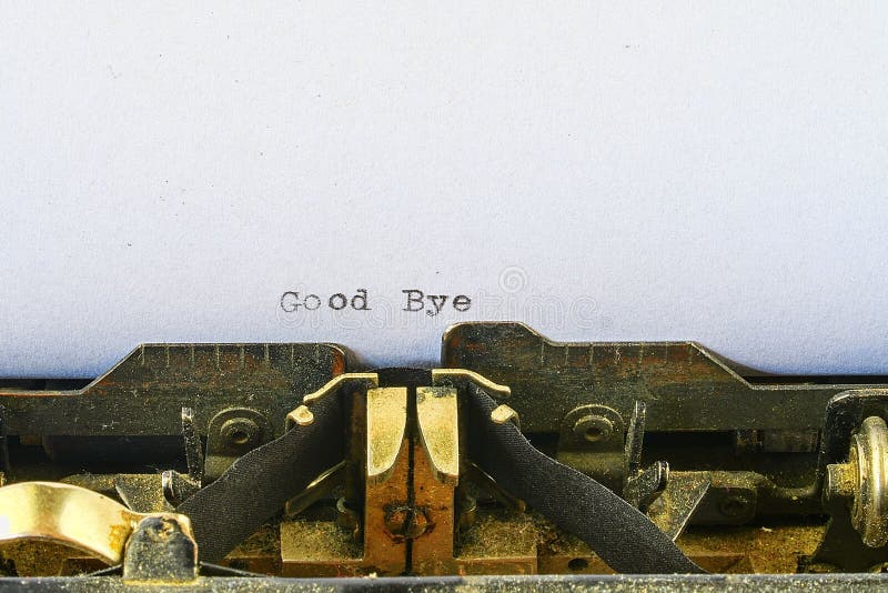 Closeup on vintage typewriter. Front focus on letters making Good Bye text. concept image with retro office tool