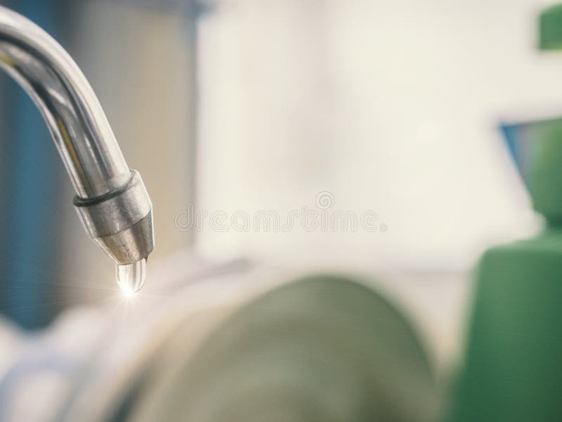 Closeup water drop , water leaking from tap after clean dish , t royalty free stock photo