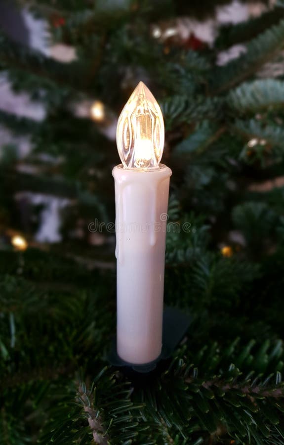 Christmas Candle on Tree. Beautiful and Clean. White Xmas Candle. Stock