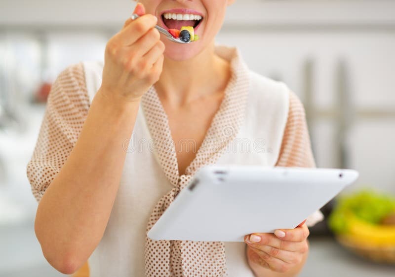 Closeup on Woman Eating Salad and Using Tablet Pc Stock Photo Image