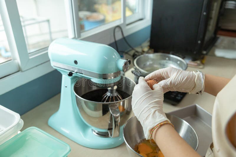 Closeup of woman, female baker hands is cracking an eggs, preparing bakery material to bake homemade cake or bakery first time royalty free stock image