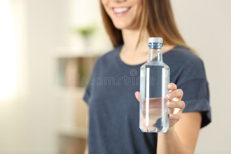 Closeup of a woman hand holding bottle of water