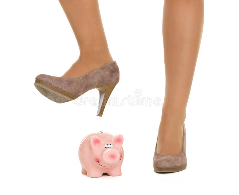 Closeup on woman leg breaking piggy bank