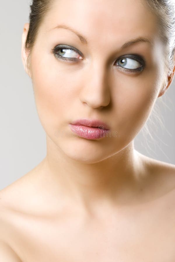 Closeup of a woman's face - wondering stock photos