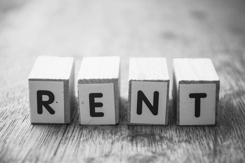 Wooden Word on Wooden Table Background Concept Rent Stock Image