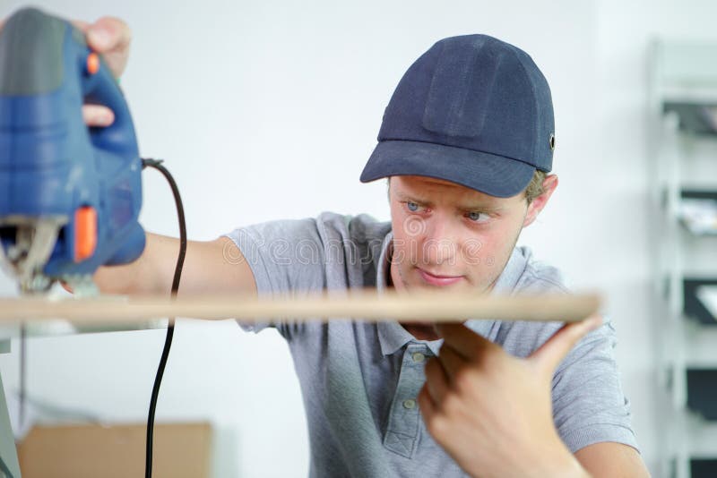 Closeup workman using jigsaw stock images Closeup workman using jigsaw stock images