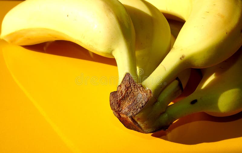 Closeup Of Yellow Bananas On Yellow Background Sweet Fruits Healthy
