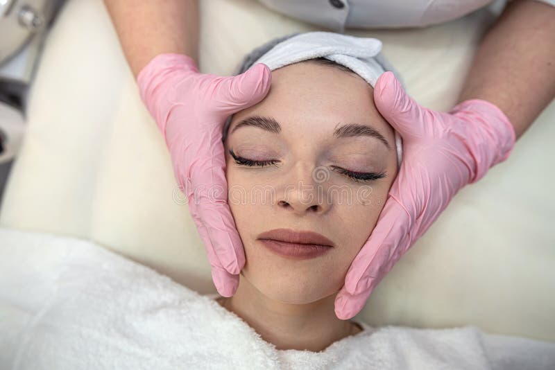Closeup Of Young Beautiful Woman Receiving Anti Aging Facial Massage In Spa Center Stock Image