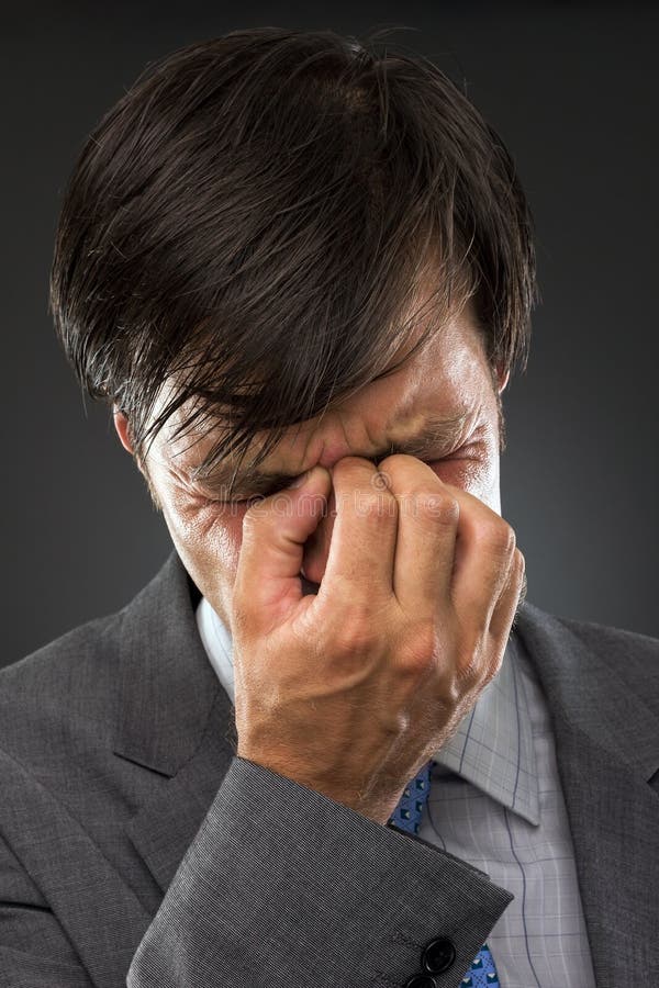 Closeup of young business man with headache royalty free stock images