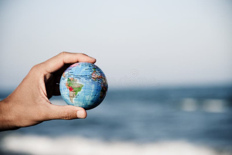 Young man with a world globe in his hand royalty free stock image Young man with a world globe in his hand royalty free stock image