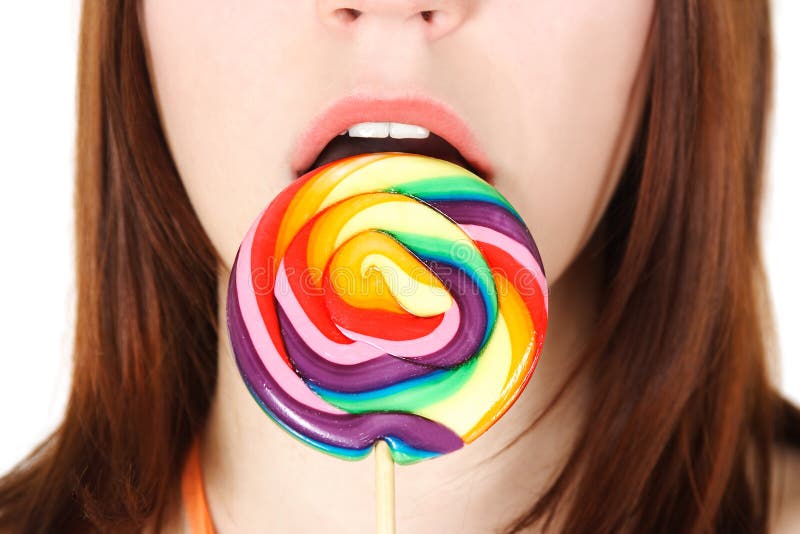 Closeup of young girl eating big lollipop