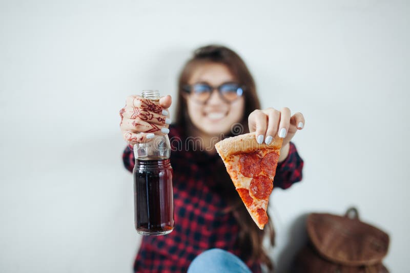 Closeup of young girl eating pizza
