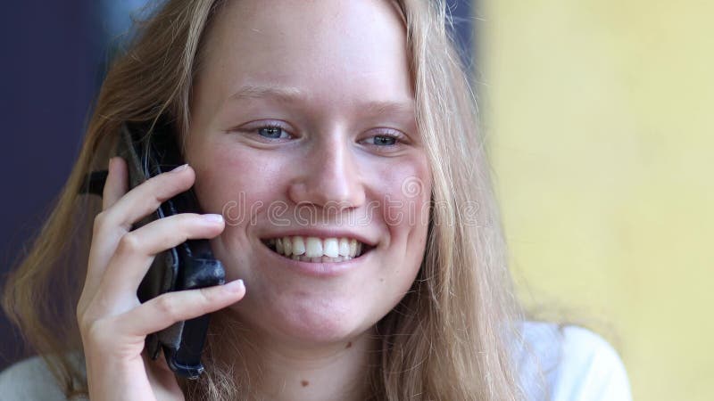 Closeup young girl talking on the phone