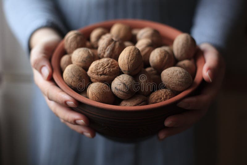 Closeup on young housewife holding jar with honey nuts. royalty free stock photos Closeup on young housewife holding jar with honey nuts. royalty free stock photos