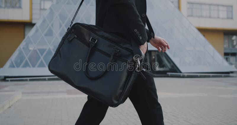 Closeup young man go to work with his briefcase. red epic. 4k