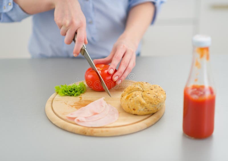 Closeup on young woman making sandwich in kitchen stock image Closeup on young woman making sandwich in kitchen stock image