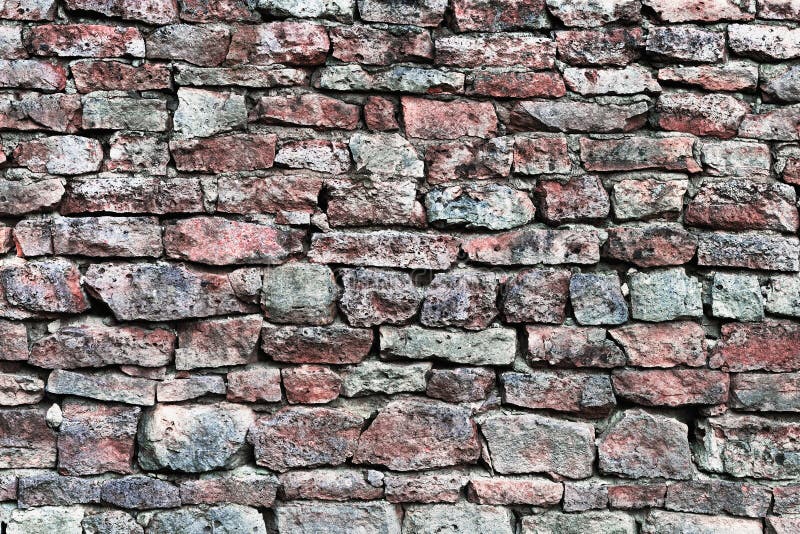 Stone wall closeup, horizontal stonewall pattern background, old aged weathered red and grey grunge limestone dolomite calcium carbonate hard sedimentary slate slab rock texture, natural grungy textured bricks, beige, yellow, reddish, gray brick vintage. Stone wall closeup, horizontal stonewall pattern background, old aged weathered red and grey grunge limestone dolomite calcium carbonate hard sedimentary slate slab rock texture, natural grungy textured bricks, beige, yellow, reddish, gray brick vintage