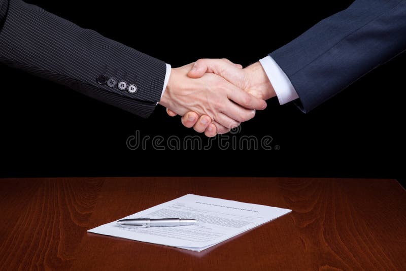 Handshake between two businessman after closing the contract. Negotiating table stock images, royalty-free photos and pictures