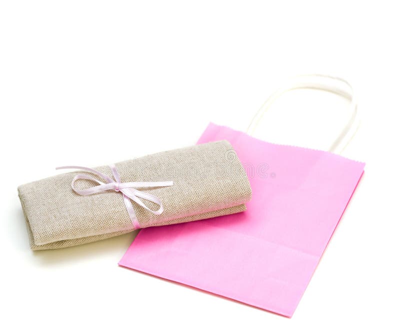 Cloth Bundle and Pink Paper Bag Isolated on White Stock Image Image