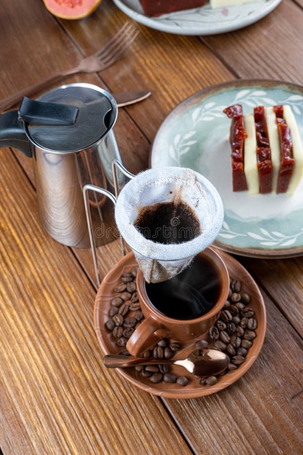 Cloth Coffee Filter Over Cup and Coffee Beans. in the Background, Guava