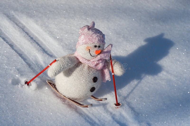 Cloth Snowman on skis down a slope with snow, stock images Cloth Snowman on skis down a slope with snow, stock images