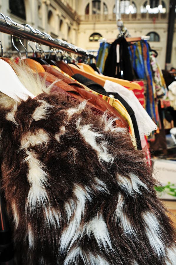 Rail of Secondhand Fur Coats for Sale in a Thrift Store Shop Stock