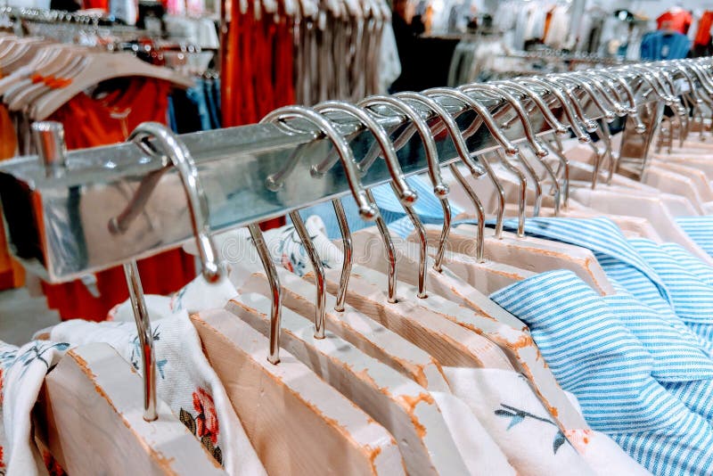 Clothes Hang on a Shelf in a Designer Clothes Store Stock Photo - Image ...